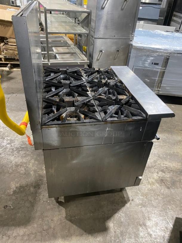 Vulcan V6B36S commercial range/oven, stainless steel, 6 burners, natural gas, with backsplash and oven rack, on legs.