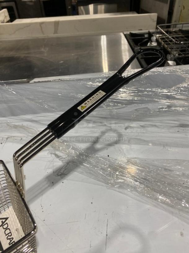 Adcraft commercial nickel-plated wire mesh fry basket, model FBR-11571, with black grip handle and warning label visible.