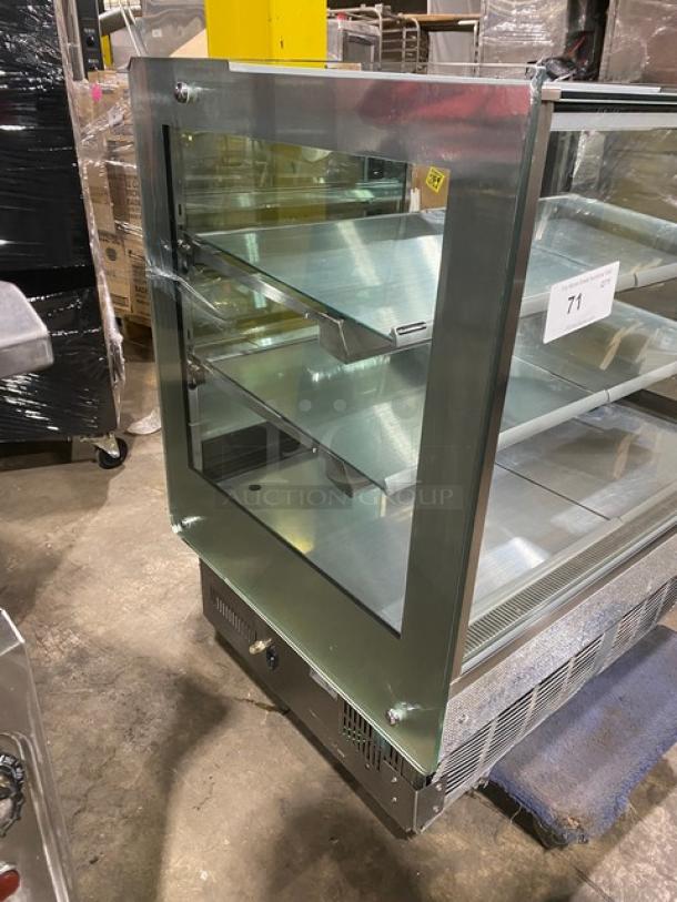 Commercial stainless steel refrigerated bakery display case, straight glass, multi-tier, rear access sliding doors, excellent condition.