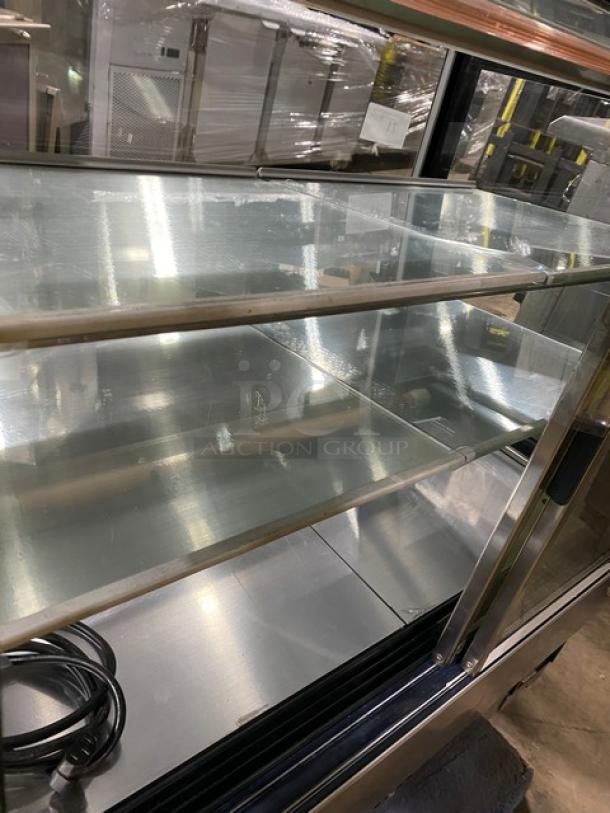Commercial stainless steel bakery display case with straight glass, multi-tier shelving, rear access double glass sliding door.