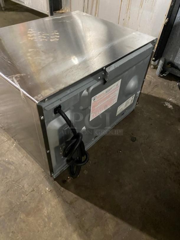 Menumaster RFS12TSW stainless steel countertop microwave oven, electric-powered, shows visible power cord and rear labels, used condition.