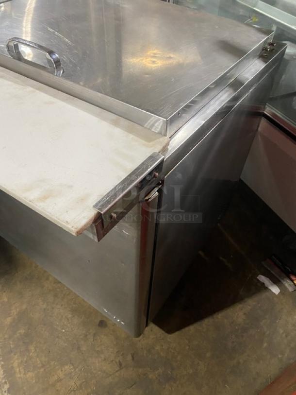 Turbo Air Super Deluxe stainless steel 2-door refrigerated prep table, with cutting board, Model TST60SD24N, on casters.