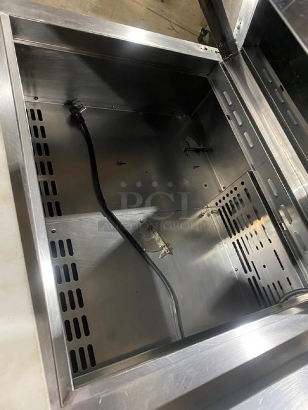 Turbo Air Super Deluxe 2 Door Refrigerated Prep Table with cutting board, chrome rack, Model TST-60SD-24-N, on casters.