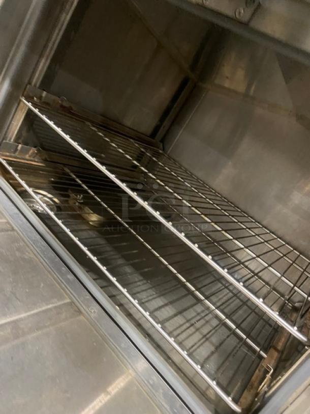 Flame-Mate ESC-3N-N stainless steel 3-compartment steam cabinet interior with wire racks, in good condition.