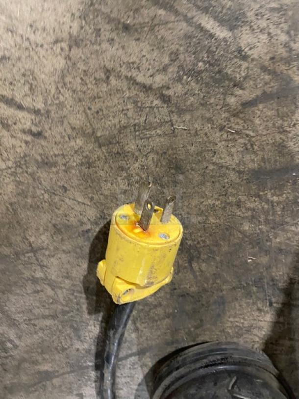 A yellow electrical plug associated with the VFA Express Model CP espresso machine, showing wear.