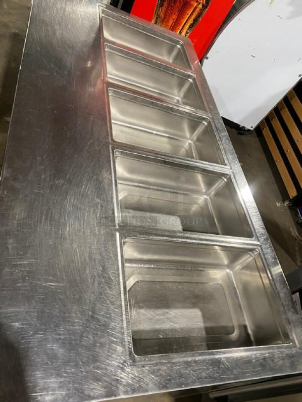 Delfield stainless steel 4-drawer refrigerated 5-well salad bar, model 18MC68PEF, on casters, with enclosed undershelf.