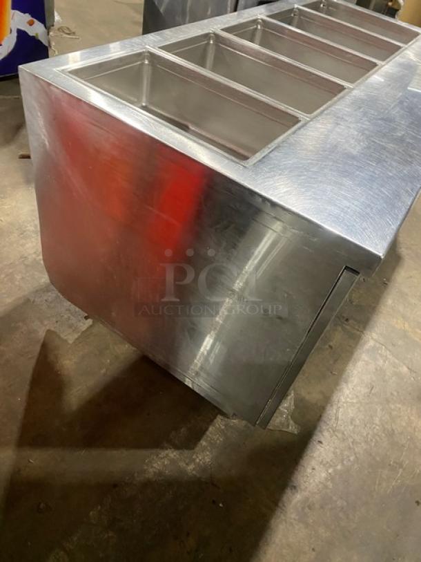 Delfield stainless steel 4-drawer refrigerated salad bar, model 18MC68PEF, with 5 wells and enclosed undershelf on casters.