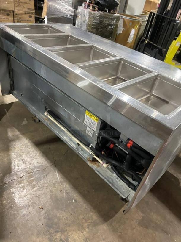 Delfield 4-drawer refrigerated salad bar, model 18MC68P-EF, stainless steel, 5 wells, casters, enclosed undershelf, 115V.