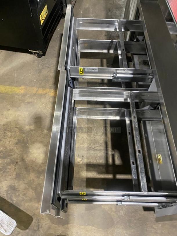 Delfield stainless steel 4-drawer refrigerated salad bar, model 18MC68PEF, on casters. Features 5-well design and enclosed undershelf.