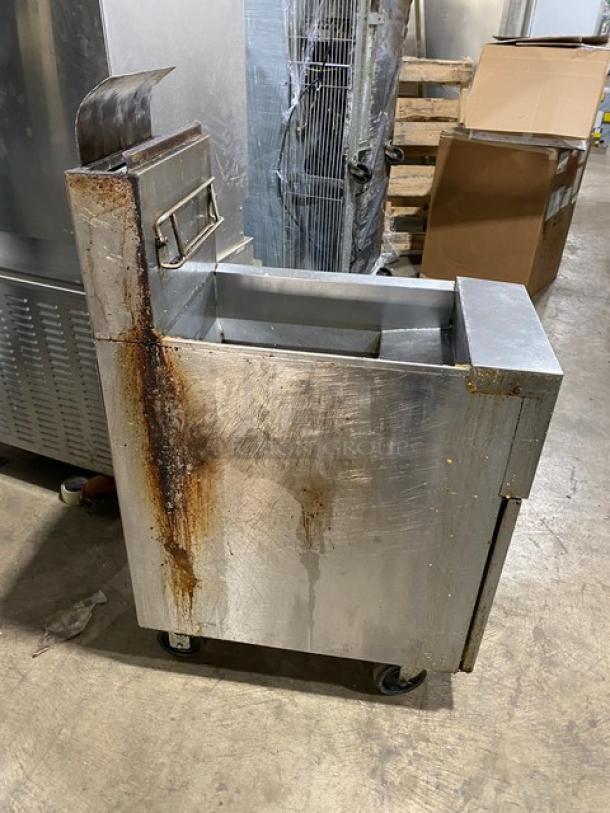 Frymaster GF40 commercial stainless steel deep fryer with backsplash and basket hanger, on casters. Visible rust, used condition.