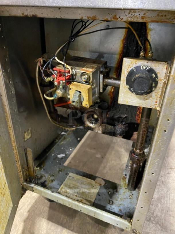 Frymaster GF40 commercial stainless steel natural gas fryer. Visible interior components, signs of wear and use. On casters.