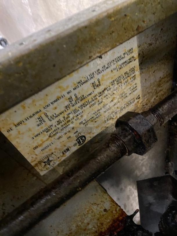 Frymaster GF40 deep fryer, stainless steel, natural gas, with backsplash, basket hanger, on casters, visible label detailing specs.