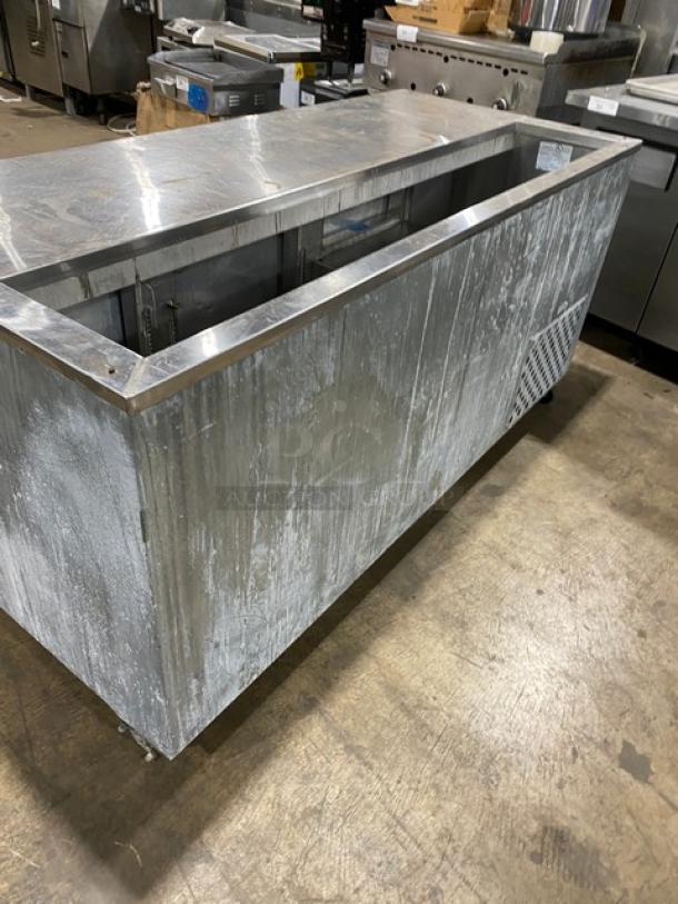 Leader stainless steel 3-door refrigerated prep table with poly-coated wire rack, on casters, in used condition.