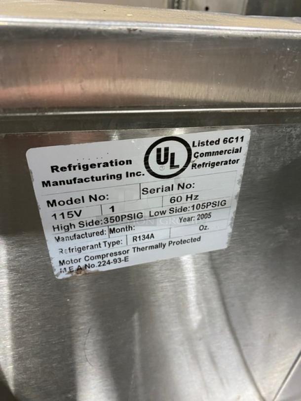 Leader Commercial Stainless Steel 3 Door Refrigerated Salad/Sandwich Prep Table, 2005 model, with poly coated wired rack, on casters.