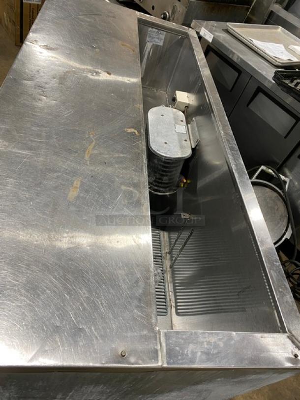 Leader Commercial Stainless Steel 3-door refrigerated salad prep table with poly-coated wired rack, on casters.