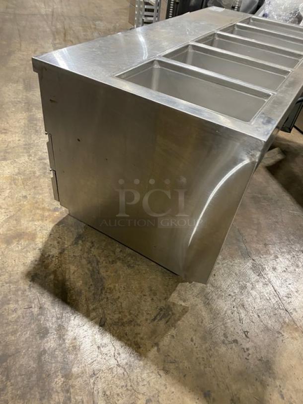 Delfield stainless steel 4-drawer refrigerated prep table, model 18MC72P-1/3, 72", with 5 cold wells, on casters.