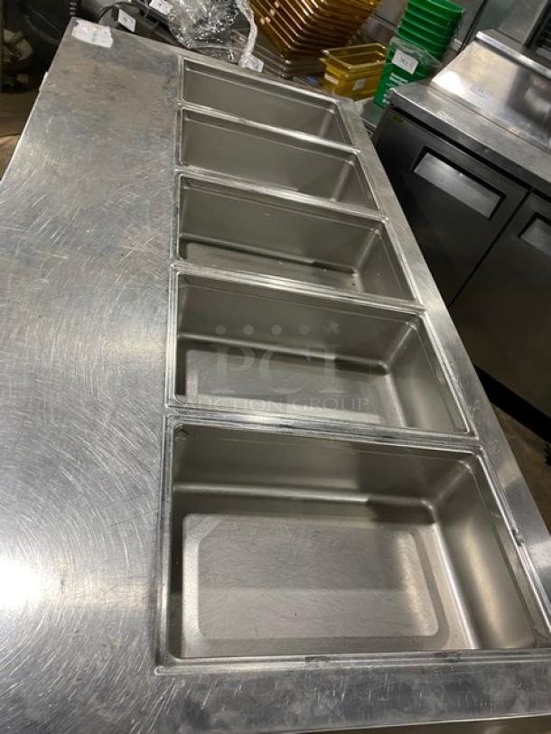 Delfield stainless steel 4-drawer refrigerated 72" prep table, model 18MC72P13, featuring 5 cold wells, on casters.