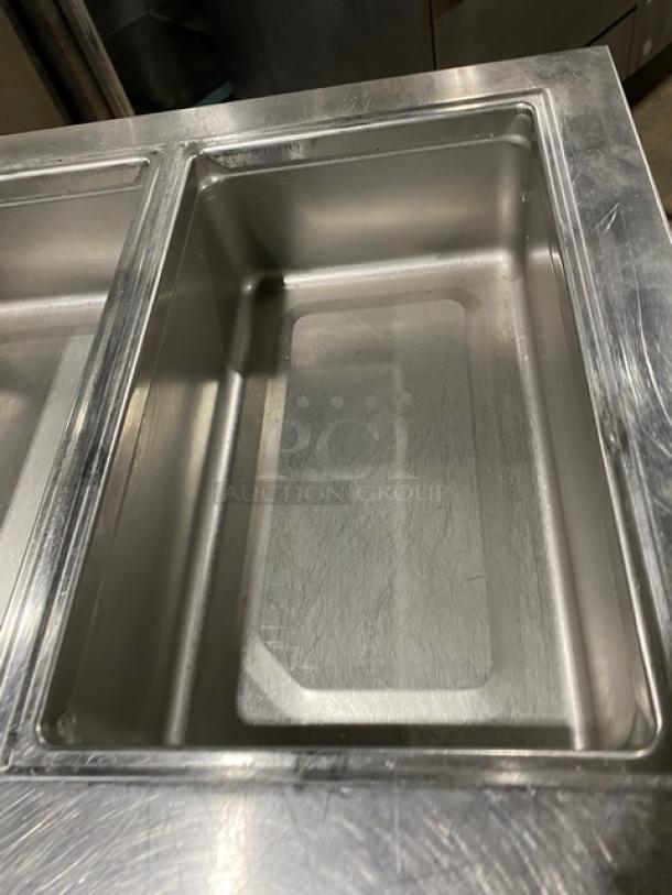 Delfield stainless steel 4-drawer refrigerated prep table, Model 18MC72P13, with cold well, on casters, in good condition.