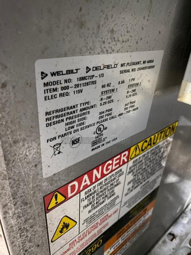 Delfield 18MC72P-1/3 prep table label showing model, serial number, electrical requirements, and safety warnings.