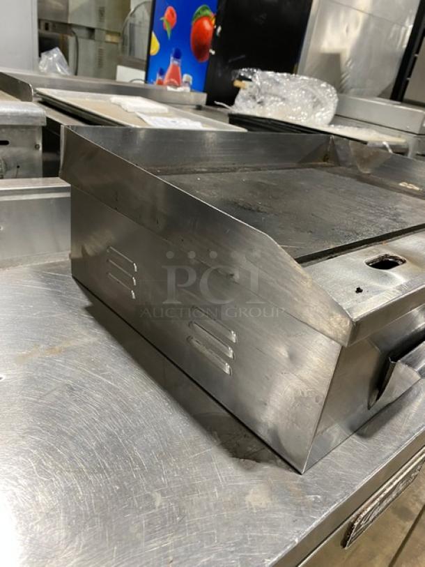 Commercial stainless steel countertop flat griddle with back and side splash, electric powered, used condition.