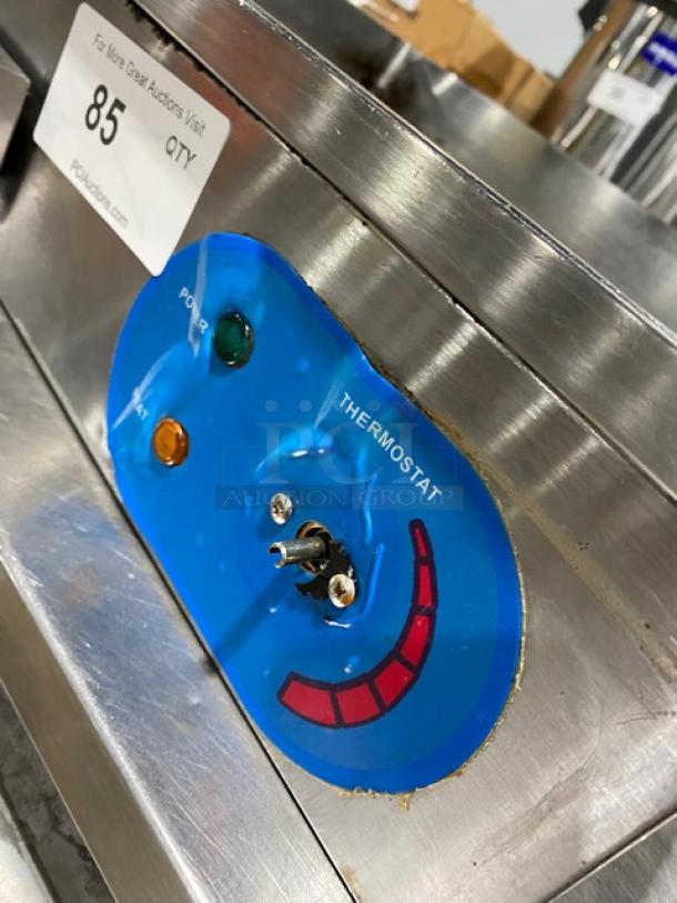 Commercial stainless steel electric countertop flat griddle with back and side splash. Features temperature control, power indicators.