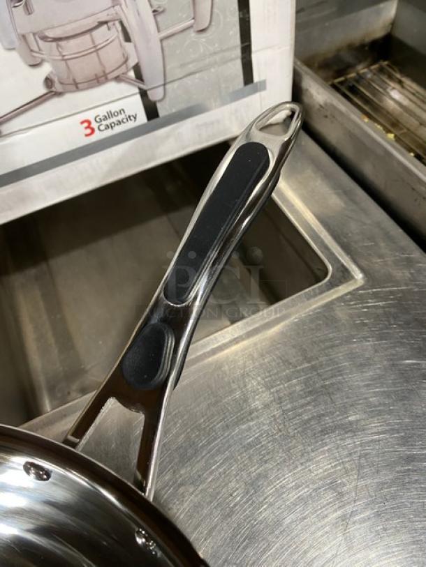 Adcraft INDWOK induction cooker handle, stainless steel with black grip, next to box indicating 3-gallon capacity.