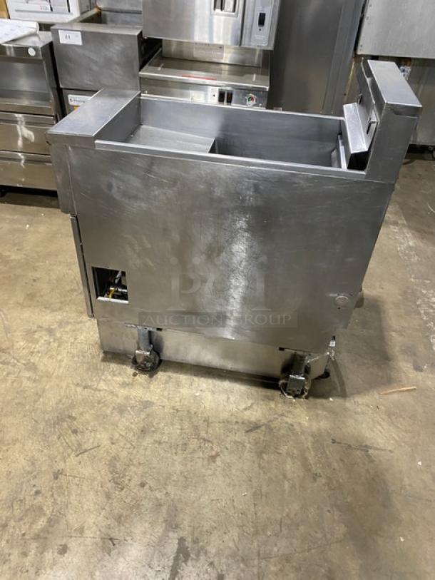Pitco SFSE14-S stainless steel electric deep fat fryer with backsplash, basket hanger, filtration system, and casters.