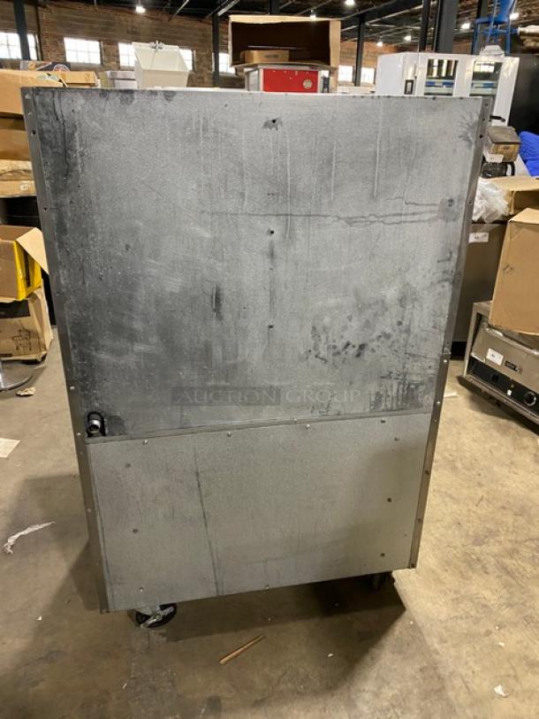 Radiance commercial stainless steel 6-burner range/oven with backsplash, wired oven rack, on casters. Gas powered, used condition.