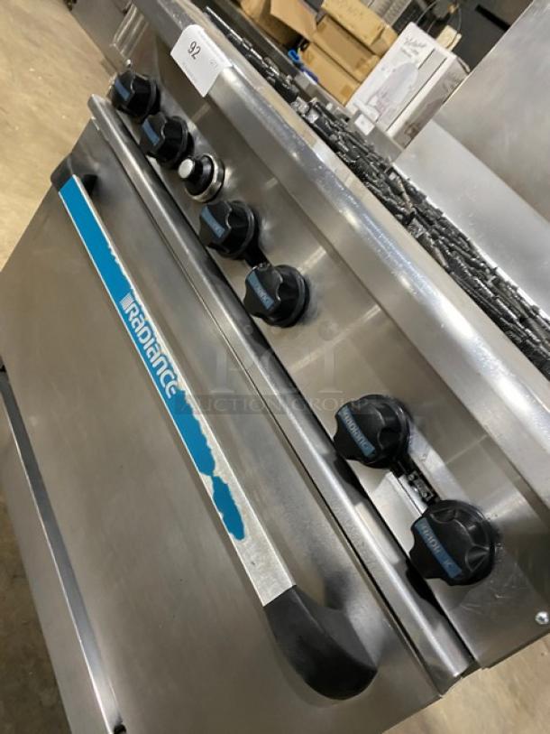 Radiance stainless steel 6-burner gas range oven combo with backsplash, wired oven rack, and casters.