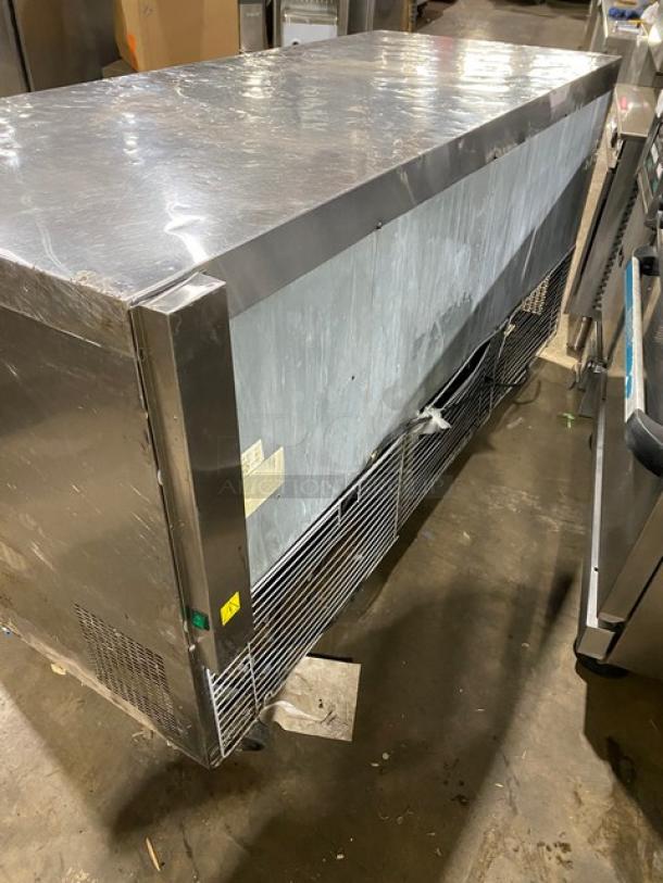 Coldline 3-door stainless steel worktop refrigerator, poly coated wire rack, on casters, commercial use, good condition.