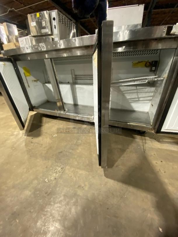 Coldline commercial stainless steel 3-door worktop refrigerator with poly-coated wire racks and casters, interior view.