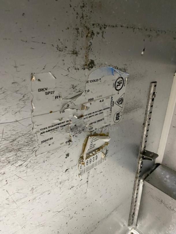 Beverage-Air SP27 prep table label with electrical specs visible; scratched surface indicates used condition.