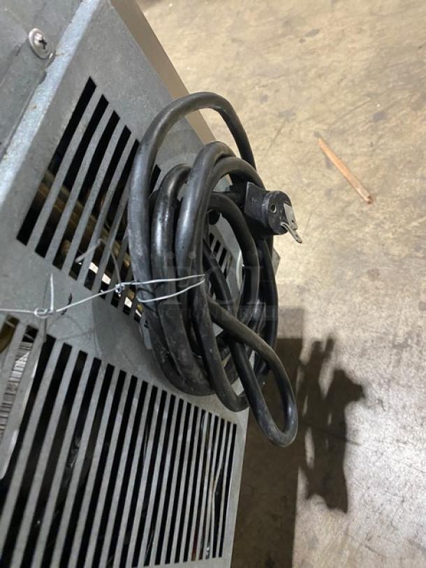 Beverage-Air SP27 commercial prep table power cord coiled, showing rear ventilation grill and side view.