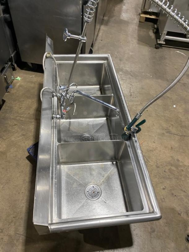 Commercial stainless steel 3-compartment dishwashing sink with backsplash, swivel faucet, jet spray attachment, and legs.