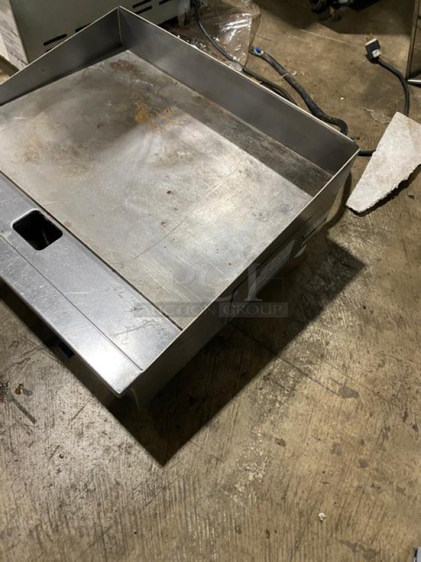 Winco Spectrum Series stainless steel electric griddle, model EGD-24M, 24" countertop, with back and side splash, on legs.