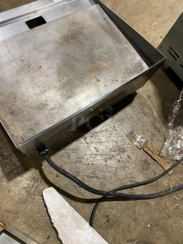 Winco EGD-24M flat griddle, stainless steel, 24" countertop model, features back and side splash, on legs, electric, used condition.