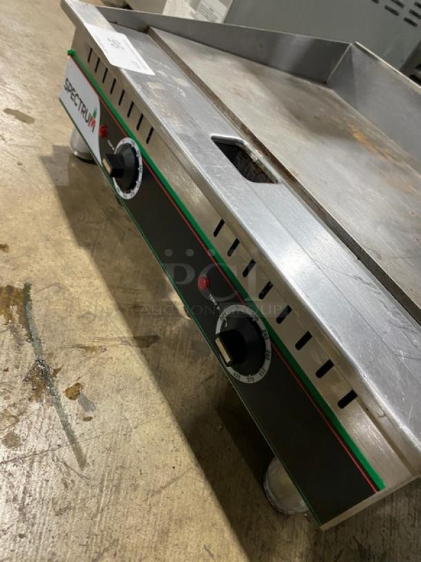 Winco Spectrum Series EGD24M electric flat griddle, stainless steel, 24" countertop, with back and side splash, on legs.