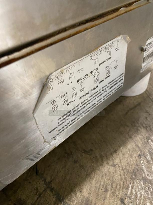 Winco Spectrum Series 24" Flat Griddle, model EGD24M, stainless steel, electric, with back and side splash, on legs. Markings show model and specs.