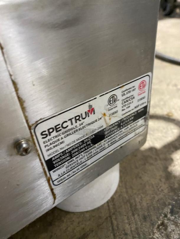 Winco Spectrum Series 24" stainless steel electric griddle, model EGD-24M, with back and side splash, 208/240V, on legs.