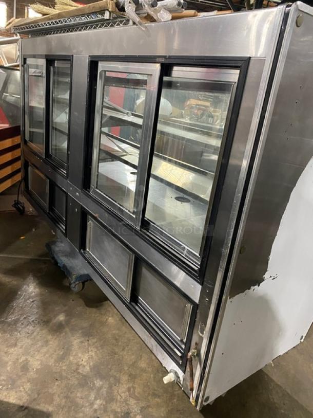 Leader NRHD96R stainless steel 96" refrigerated deli display case with curved glass, rear sliding doors, and storage compartment.