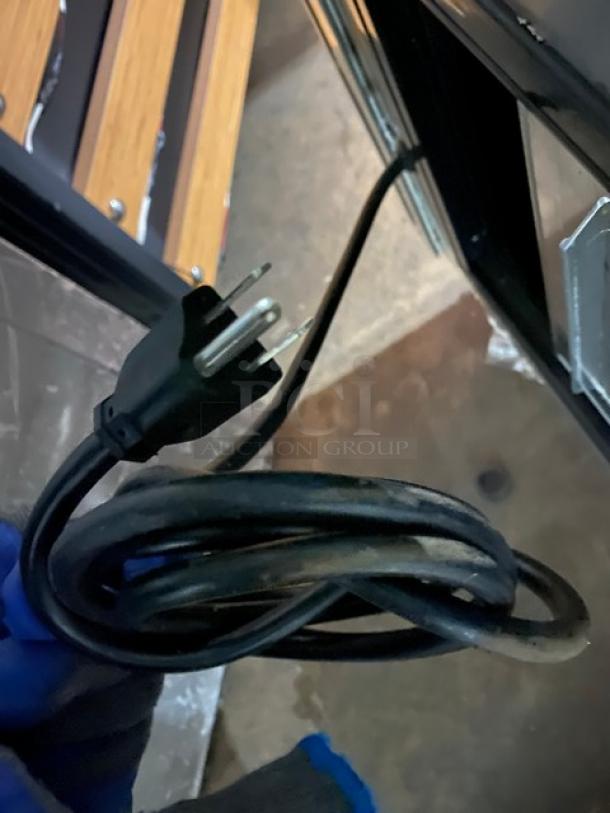 Power cord of Leader NRHD96R refrigerated display case, showing a three-prong plug. Condition appears used.