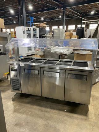 Turbo Air JBT72N commercial stainless steel 3-door cold food buffet table with overhead sneeze guard, poly coated rack, on casters.