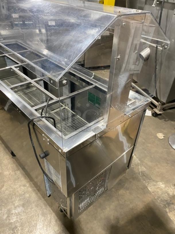 Turbo Air stainless steel 3-door refrigerated buffet table with sneeze guard, model JBT72N, on casters, poly coated rack.