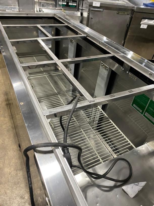 Turbo Air 3-door refrigerated buffet table, model JBT-72-N. Stainless steel, sneeze guard, poly coated rack, on casters.