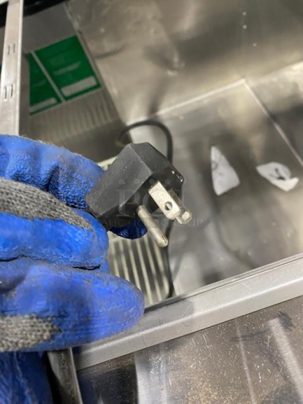 Turbo Air stainless steel 3-door refrigerated buffet display table, model JBT72N. Features overhead sneeze guard, poly-coated wired rack, and casters.