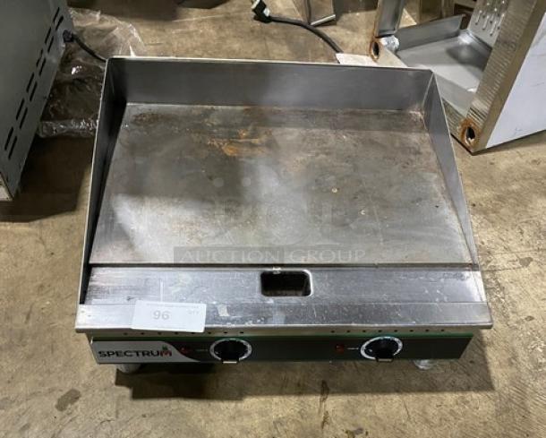 Winco Spectrum Series stainless steel electric griddle, model EGD-24M. Flat 24" surface, back and side splash, on legs. 208/240V. Slight wear.