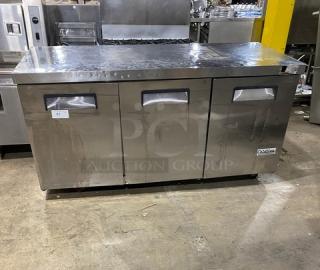 Coldline commercial stainless steel 3-door worktop refrigerator on casters, with poly-coated wired rack, in used condition.