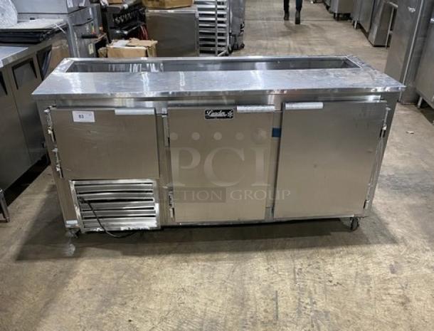 Leader Commercial Stainless Steel 3 Door Refrigerated Prep Table with poly-coated rack and casters, good condition.