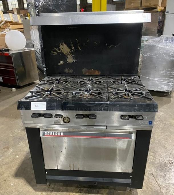 Garland stainless steel 6-burner gas range/oven combo with backsplash, overhead salamander shelf, wired oven rack. Used condition.