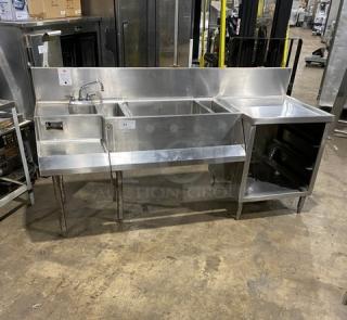 Commercial stainless steel cocktail station with backsplash, dump sink, swivel faucet, ice bin, speed rail, and legs.